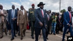 South Sudan's President Salva Kiir, center, arrives back in the country from peace talks in Addis Ababa, at the airport in Juba, South Sudan, June 22, 2018.