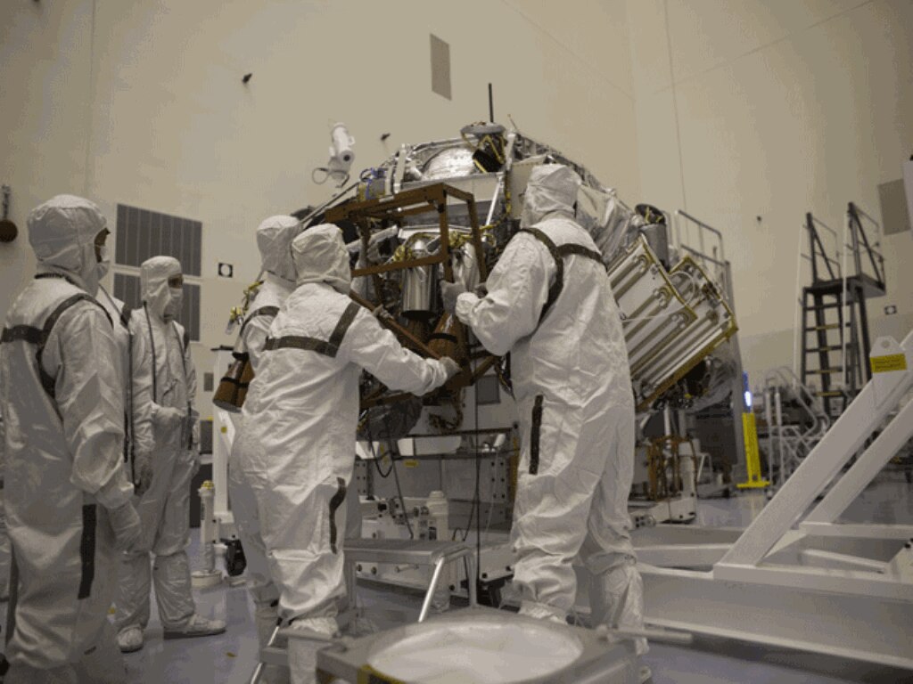 Technicians wrap Curiosity inside a protective cover, carrying material for use during entry, descent and landing of the MSL's rover. (NASA/Dimitri Gerondidakis)