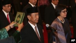 Wiranto dan Sri Mulyani Indrawati dilantik masing-masing sebagai Menkopolhukam dan Menteri Keuangan, di Istana Negara Jakarta (27/7). (AP/Tatan Syuflana)