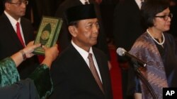 Jenderal (purn.) Wiranto, kiri saat dilantik sebagai Menteri Koordinator Politik, Hukum dan Keamanan RI di Istana Negara, Jakarta, Rabu (27/7). 