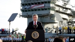 Then President George Bush declares the war over in Iraq May 1, 2003. Behind him on board the carrier USS Abraham Lincoln is a banner reading: "Mission Accomplished."
