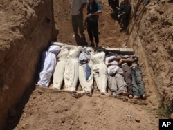 An image purports to show several bodies being buried near Damascus, Syria, around the time of an alleged chemical attack on one of its suburbs, Aug. 21, 2013.