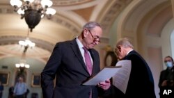 FILE - Senate Majority Leader Chuck Schumer talks to reporters about his efforts to advance their expansive social and environment bill, following a Democratic policy meeting at the Capitol in Washington, Dec. 14, 2021. 