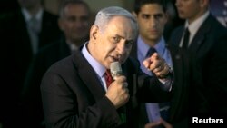 Israel's Prime Minister Benjamin Netanyahu gestures as he speaks to supporters of his Likud party as he campaigns in Netanya, north of Tel Aviv, March 11, 2015.