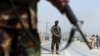 Afghan National Army soldiers stand guard at a checkpoint on the Jalalabad-Kabul road, on the outskirts of Kabul, April 28, 2019.