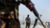 Afghan National Army soldiers stand guard at a checkpoint on the Jalalabad-Kabul road, on the outskirts of Kabul, April 28, 2019.