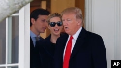 FILE - President Donald Trump and his family, daughter Ivanka Trump, her husband senior adviser Jared Kushner walks out of the Oval Office of the White House.