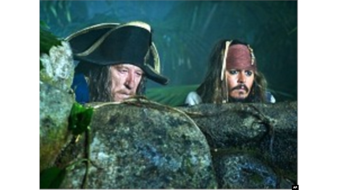 Captain Sparrow (Johnny Depp, right) and Hector Barbossa (Geoffrey Rush) spy on a Spanish encampment during the search for the legendary Fountain of Youth.