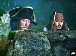 Captain Sparrow (Johnny Depp, right) and Hector Barbossa (Geoffrey Rush) spy on a Spanish encampment during the search for the legendary Fountain of Youth.