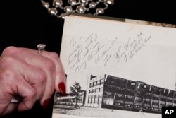 Beverly Young Nelson the latest accuser of Alabama Republican Roy Moore, shows her high school yearbook signed by Moore, at a news conference, in New York, Nov. 13, 2017.