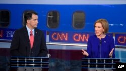 Republican presidential candidate Carly Fiorina, right, speaks as Scott Walker looks on during the Republican presidential debate, Sept. 16, 2015.