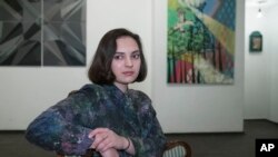 Art-curator Maria Pogodina poses for a photo in Moscow, Russia, March 3, 2018. When she looks at the current state of affairs in Russia today, Maria feels like she's living in a "surreal" reality, with "absurd" news flashes, blocked domain names and atmosphere of heightened pressure: "We spend a lot of our conscious life on the internet and it now feels really controlled and unpleasant." 