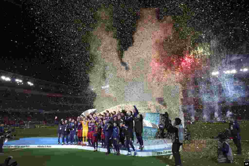 FC Barcelona players celebrate during an award ceremony after winning their final match against River Plate 3-0 at the FIFA Club World Cup soccer tournament in Yokohama, near Tokyo, Japan.