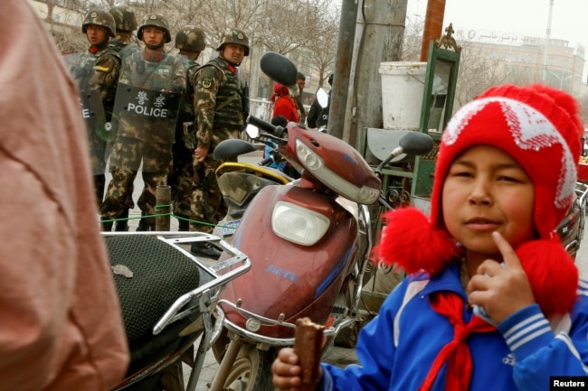 Security personnel keep watch in a street in Kashgar, Xinjiang Uighur Autonomous Region, China, March 23, 2017.