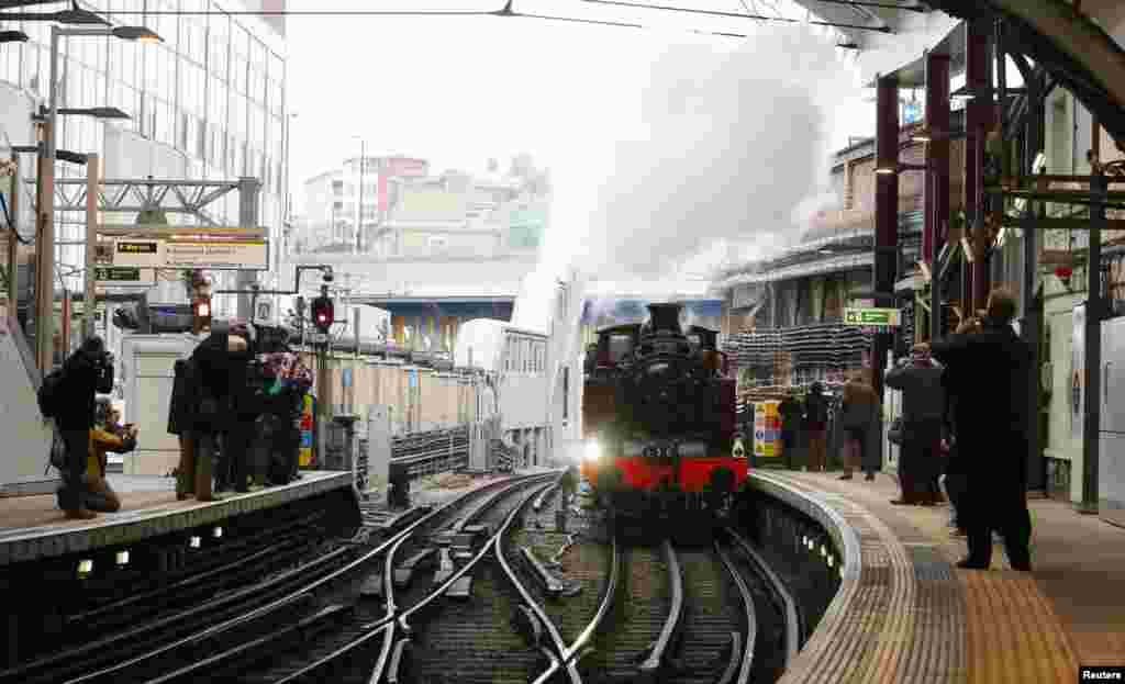 A steam train enters Farringdon underground station in London. The train, an 1898-built steam engine known as Met Locomotive No 1, pulled carriages along part of the Hammersmith &amp; City Line, as part of the celebrations to mark 150th anniversary of the world&#39;s oldest underground passenger railway.