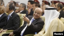 Yemen's President Abd-Rabbu Mansour Hadi (C) speaks with Gulf Cooperation Council (GCC) Secretary General Abdullatif al-Zayani during a ceremony in Sanaa November 19, 2012. 