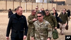 FILE - Acting Defense Secretary Pat Shanahan, left, arrives in Kabul, Afghanistan, Feb. 11, 2019, to consult with Army Gen. Scott Miller, right, commander of U.S. and coalition forces, and senior Afghan government leaders. 