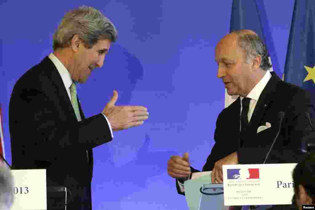 French Foreign Affairs minister Laurent Fabius (R) speaks with U.S. Secretary of State John Kerry following a news conference at the ministry in Paris, February 27, 2013. REUTERS/Philippe Wojazer (FRANCE) - RTR3ECNE