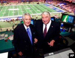 FILE - Fox broadcasters Pat Summerall, left, and John Madden stand in the broadcast booth at the Superdome before Super Bowl 36 on Feb. 3, 2002, in New Orleans.