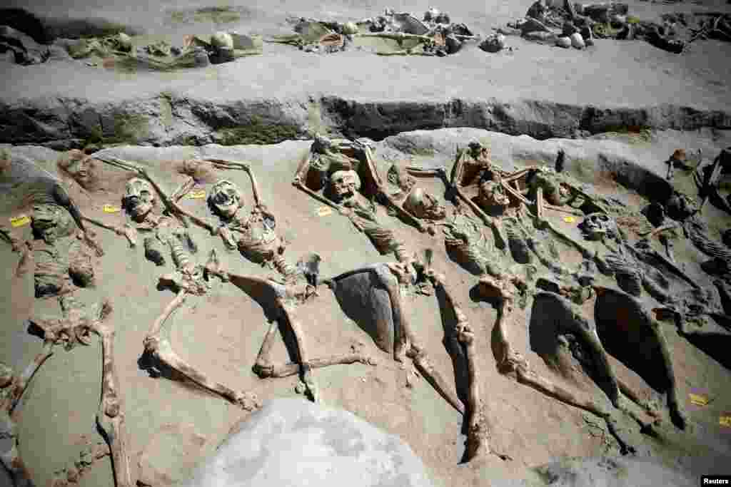 Skeletal remains, with iron shackles on their wrists, are laid in a row at the ancient Falyron Delta cemetery in Athens, Greece.