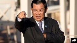 Cambodia's Prime Minister Hun Sen gestures as he arrives for a group photo of leaders at the 11th Asia-Europe Meeting (ASEM) in Ulaanbaatar, Mongolia, Saturday, July 16, 2016. (AP Photo/Mark Schiefelbein)