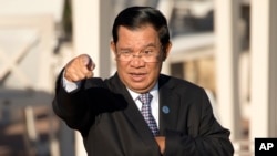 FILE - Cambodia's Prime Minister Hun Sen gestures as he arrives for a group photo of leaders at the 11th Asia-Europe Meeting (ASEM) in Ulaanbaatar, Mongolia, Saturday, July 16, 2016. (AP Photo/Mark Schiefelbein)