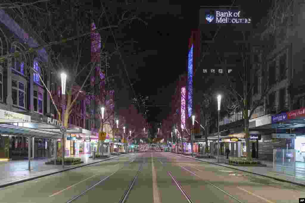 An empty Swanston Street is seen at night in the Central Business District as a COVID-19 shutdown prepares to start Melbourne, Australia.