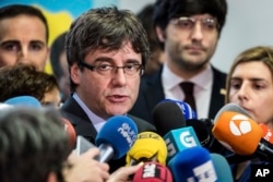 Fugitive Catalan leader Carles Puigdemont addresses the media in Brussels, Belgium, Jan. 24, 2018.