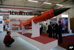 A visitor looks at a BQM-177A Target Drone built by U.S. company Kratos at the Paris Air Show, in Le Bourget, east of Paris, June 20, 2017.