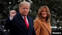 U.S. President Donald Trump walks with first lady Melania Trump while departing for Palm Beach, Fla., from the White House in Washington, Feb. 1, 2019.