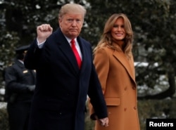 President Donald Trump walks with first lady Melania Trump while departing for Palm Beach, Fla., from the White House in Washington, Feb. 1, 2019.