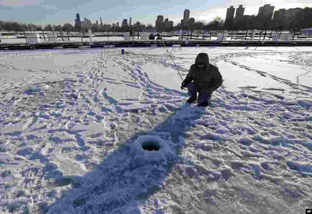 A man ice fishes at Lake Michigan Water Trail Launch Site in Chicago, Illinois, Dec. 18, 2013.