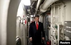 FILE - Ukrainian President Petro Poroshenko visits the Arleigh Burke-class guided missile destroyer USS Donald Cook in Odessa, Ukraine, Feb. 26, 2019.