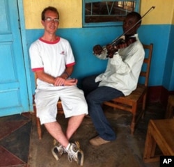 Berklee alumnus Aaron Colverson with a student at Matende High School in Kakamega, Kenya.