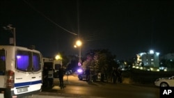 Security officials park near the approach toward the Israeli embassy in Amman, Jordan, on Sunday, July 23, 2017.