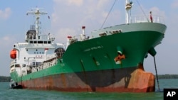 Singapore-owned tanker Naniwa Maru 1 is anchored at Klang port, Malaysia, Wednesday, April 23, 2014 after being robbed by pirates. Pirates stopped the tanker in the Malacca Strait and stole several million liters of diesel fuel it was carrying, Malaysian marine police said Wednesday. Marine police deputy commander Abdul Rahim Abdullah said the tanker was sailing from Singapore to Myanmar when it was boarded by up to 10 pirates armed with pistols and machetes early Tuesday off the port. (AP Photo/Lai Seng Sin)