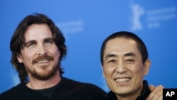 British actor Christian Bale (L) and Chinese director Zhang Yimou pose during a photocall to promote the film "The Flowers of War" February 13, 2012.