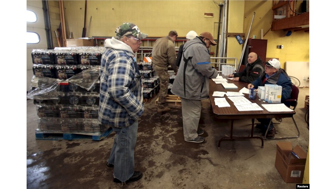 Flint residents pick up bottled water and water filters at a fire station in Flint, Michigan, Jan. 13, 2016.