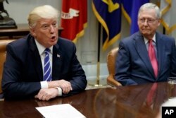 FILE - Senate Majority Leader Mitch McConnell, R-Ky., right, listens as President Donald Trump speaks during a meeting with congressional leaders and administration officials on tax reform, in the Roosevelt Room of the White House, Sept. 5, 2017, in Washington.