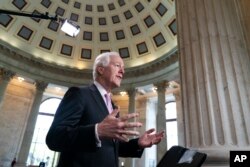 FILE - Majority Whip John Cornyn, R-Texas, takes questions during a TV news interview on Capitol Hill in Washington, April 26, 2018.