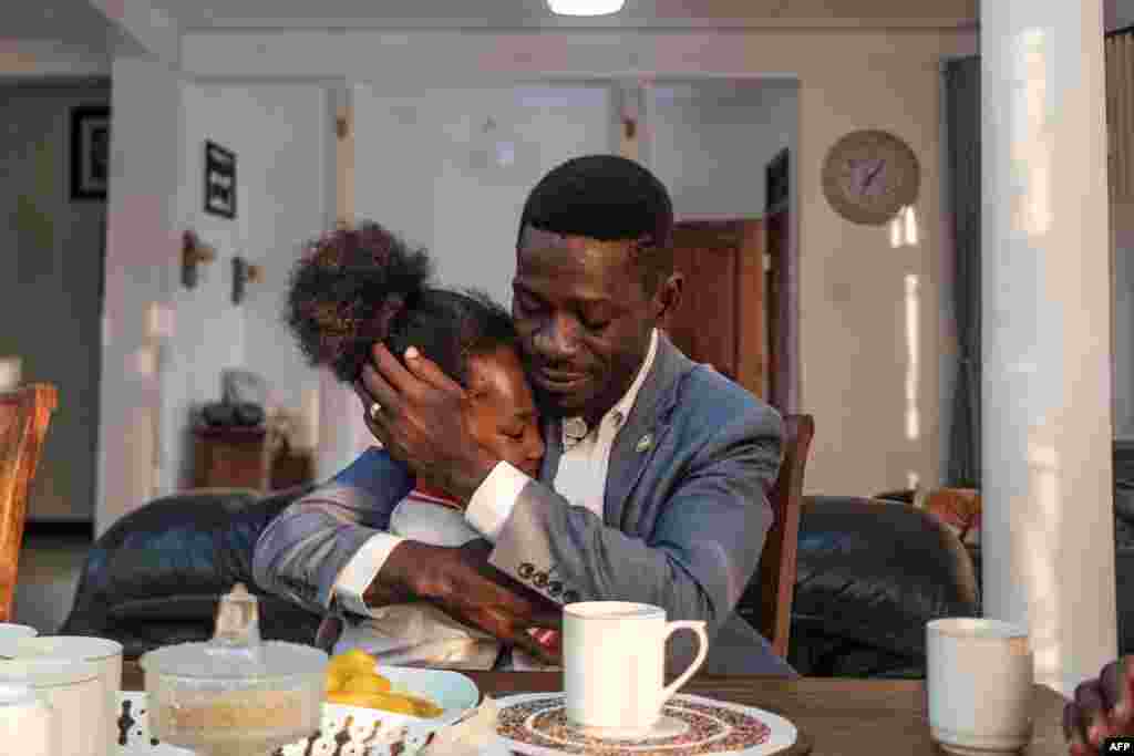 Ugandan pop star and presidential candidate Bobi Wine and his daughter Subi share a moment during a morning meal in his home in Kampala.