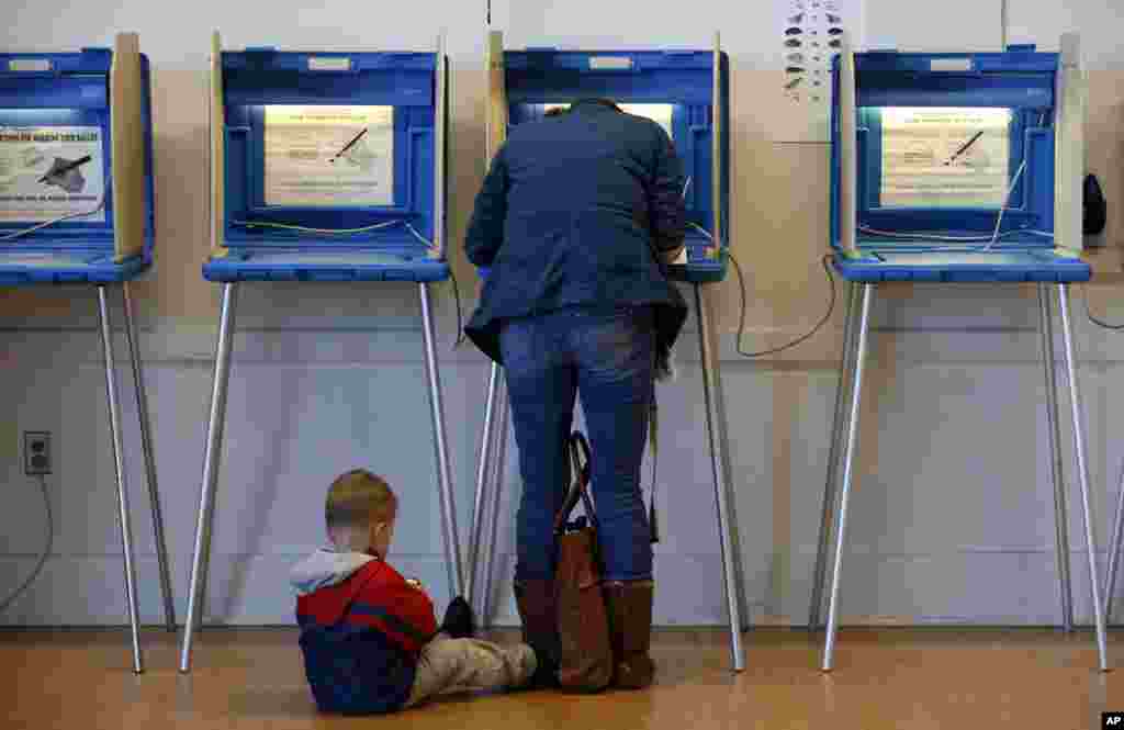 A boy waits as his mother votes at Precinct 11 at City Hall in Bloomington, Minnesota.