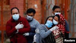 Family members mourn a coronavirus disease (COVID-19) victim as the country recorded the highest daily increase in death since the pandemic began, in Kathmandu, Nepal May 3, 2021. 
