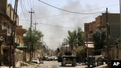 Iraqi counterterrorism forces patrol in Fallujah. (June 27, 2016.)