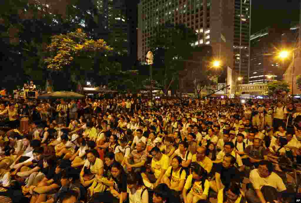 Hundreds of protesters stage a peaceful sit-ins overnight on a street in the financial district in Hong Kong Wednesday, July 2, 2014, following a huge rally to show their support for democratic reform and oppose Beijing's desire to have the final say on c