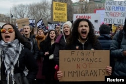 People participate in a protest against U.S. President Donald Trump's immigration policy and the recent Immigration and Customs Enforcement (ICE) raids in New York City, on Feb. 11, 2017.