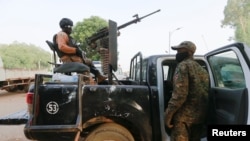 FILE - A soldier sits on one of the trucks used to bring back the girls who were kidnapped from a boarding school in the northwest Nigerian state of Zamfara, following their release in Zamfara, Nigeria, March 2, 2021. 