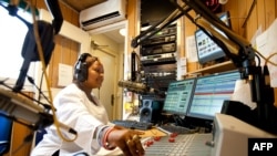 FILE - Radio Miraya host Lubna Lasu broadcasts the Betna Weekend Edition program in the southern Sudanese city of Juba, April 10, 2010. 