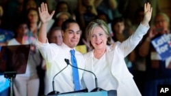 Democratic presidential candidate Hillary Clinton, right, stands with Housing and Urban Development Secretary Julian Castro, left, after she was introduced during a campaign event in San Antonio, Texas, Oct. 15, 2015.