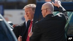 President Donald Trump steps from his motorcade vehicle as he arrives to attend service at Saint John's Church in Washington, March 17, 2019. 